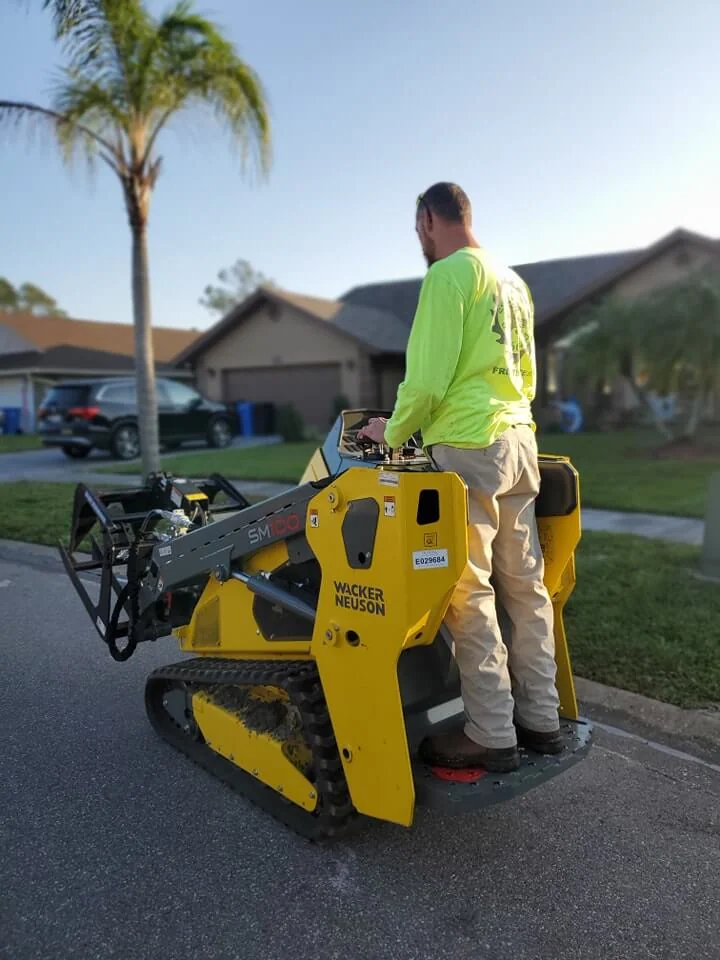Stump grinding machine operated by professional in Tampa
