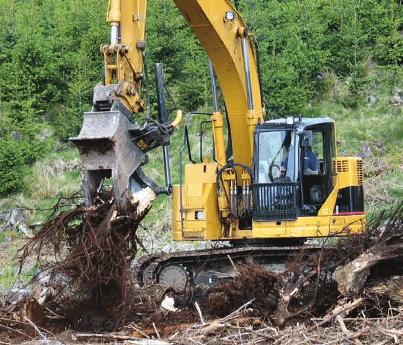 Full stump removal using excavator pulling roots from soil